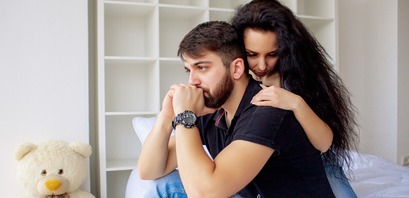 رجل حزين وزوجته تُسانده