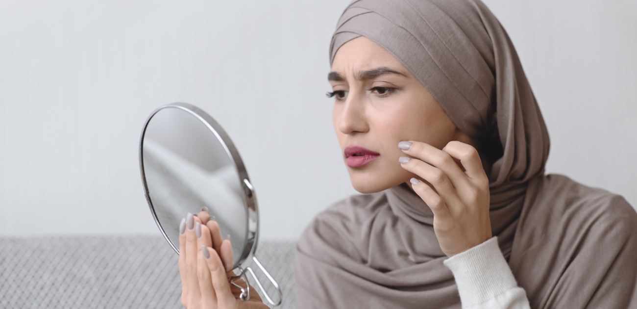 امرأة تنظر في مرآتها