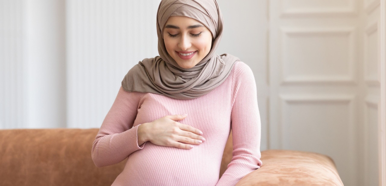 امرأة حامل تنظر إلى بطنها